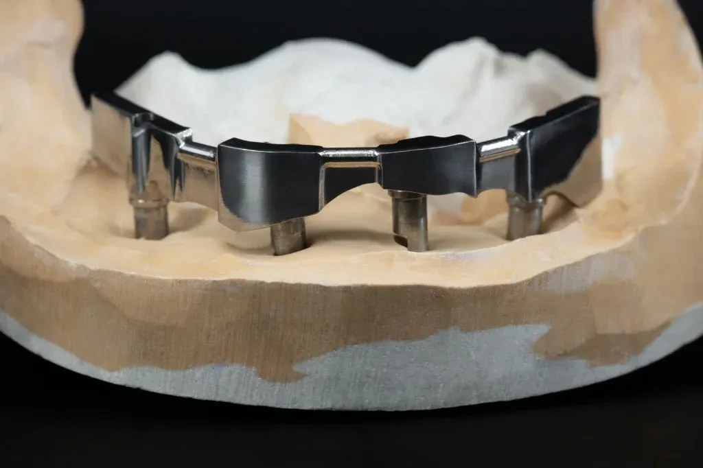 Full-arch implant restoration for group implant volume