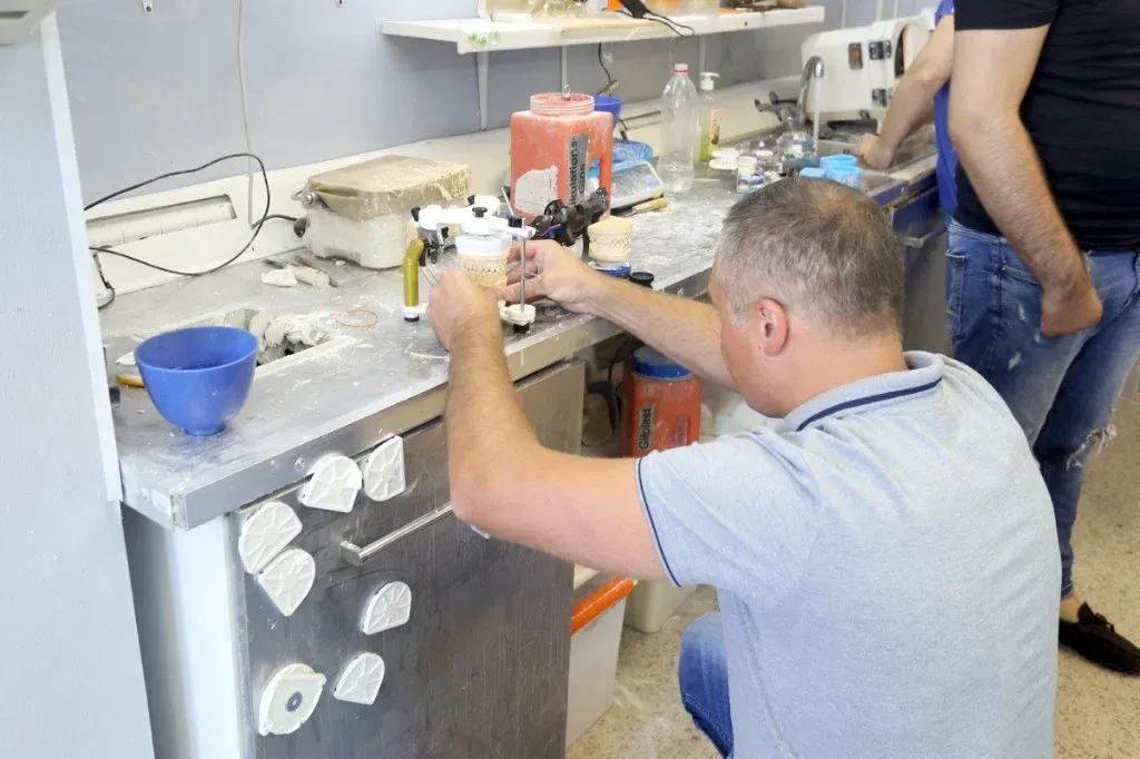 Articulated full-mouth case on the bench with the occlusion being checked